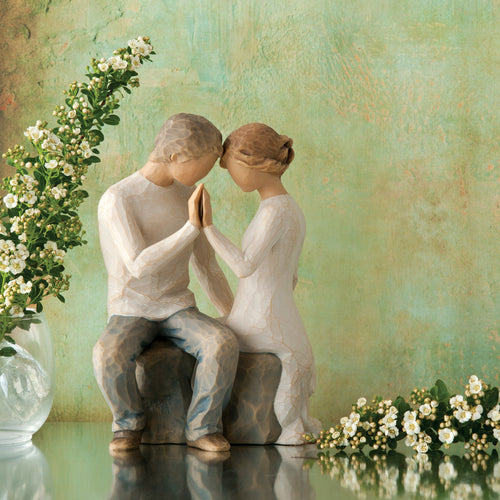 Willow Tree Around You, 6.5”h hand-painted figure of couple seated across from each other, heads and hands together, both in neutral clothing, in front of mossy green painting