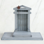 Grey wooden barn figurine open - brown star standing on it