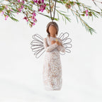 Front: Angel Ornament with wire wings, darker skin, arms crossed over gold heart, dress carved with symbols of remembrance