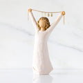 Front view: figure in cream dress holding gold chain above her head with year 2025 on it