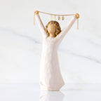 Front view: figure in cream dress holding gold chain above her head with year 2025 on it