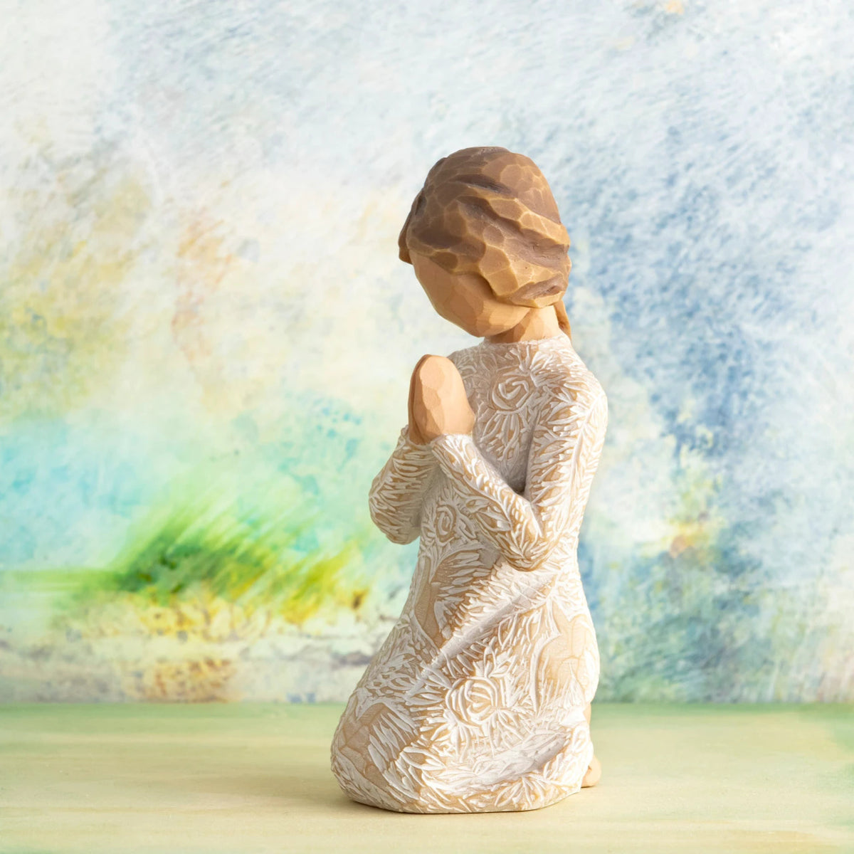 Willow Tree Prayer of Peace, 4”h hand-painted kneeling figure in cream dress heavily carved with birds and flowers, hands in prayer pose, in front of dusty blue/green painting