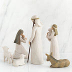 Wiseman figurines around girl figurines in white with hair scarves on - donkeys and sheep figurines around them