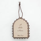 Round cream pendant with wooden outline - center says 'a child is born'