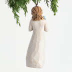 Back view, female figure in cream dress, holding bouquet of blue forget-me-not flowers to face. Hook and loop affixed to head