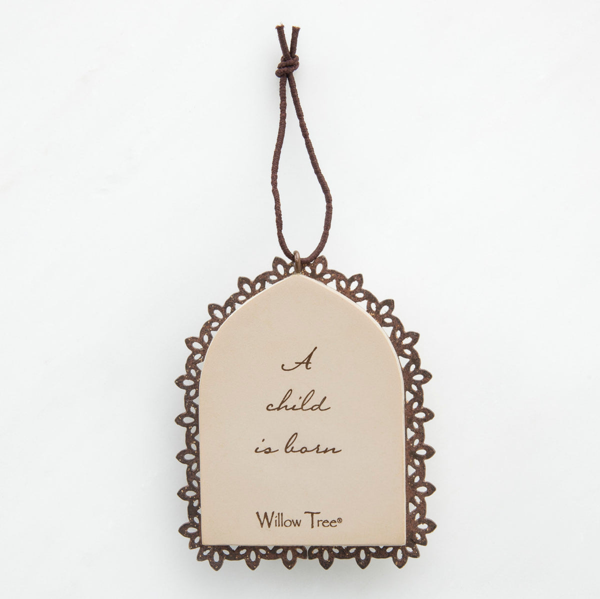 Round cream pendant with wooden outline - center says 'a child is born'