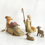 Camel figurine, sheep figurines, and wise man figurine all laid out facing the back