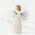 Side view of brunette angel figurine in white dress holding hands in prayer with black wire wings