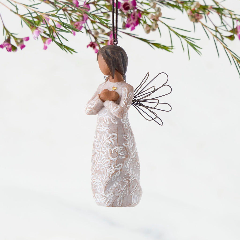 Left Side: Angel Ornament with wire wings, darker skin, dress carved with symbols of remembrance