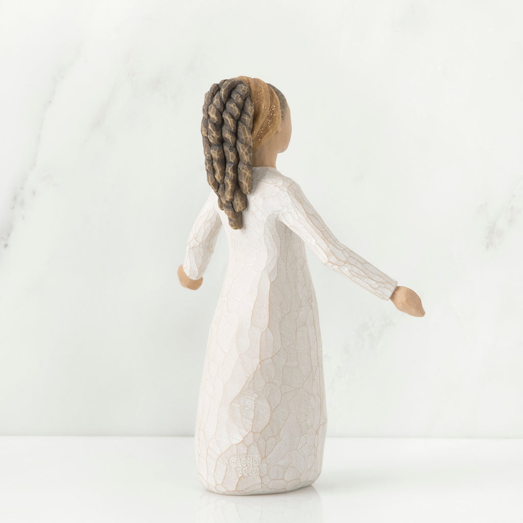 Back view of brunette girl figurine in white dress holding her hands out