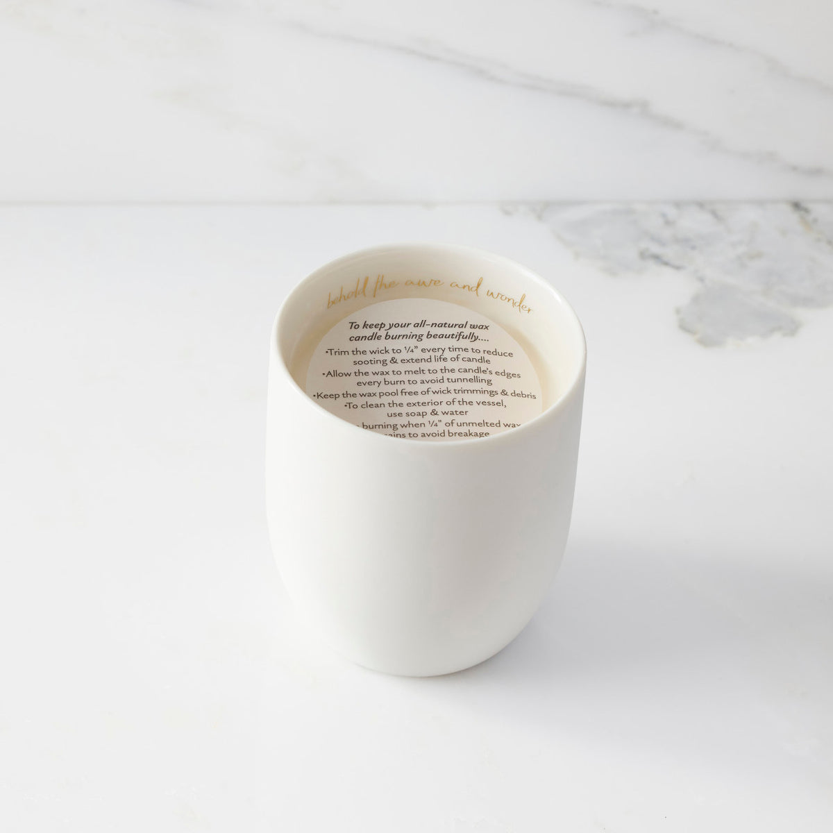 Top view of candle with vellum insert sheet with burning instructions