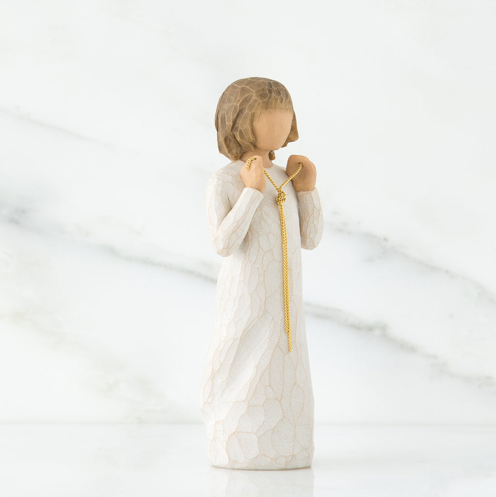 Side view of brunette girl figurine in white dress holding gold chain