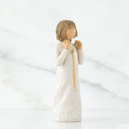 Side view of brunette girl figurine in white dress holding gold chain