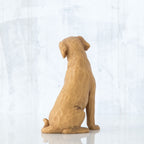 Golden dog figurine sitting - back view