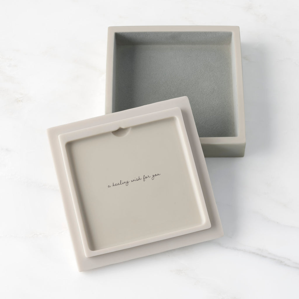 White resin box with detached lid showing sentiment on lid back; velvety gray-green finish in box base