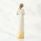 Back view of brunette woman wearing white dress with gold bottom