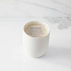 Top view of candle with vellum insert sheet with burning instructions