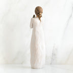 Back view of brunette woman in white dress standing up