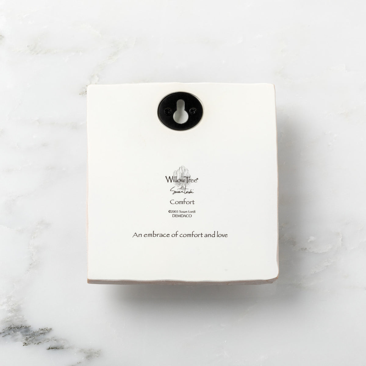 Back of white plaque reading piece title and sentiment, with Willow Tree logo