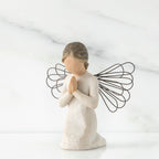 Small faceless girl kneeling praying with black wire angel wings
