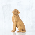 Light wooden dog figurine sitting up