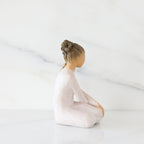 Right-facing view: seated figure in cream dress with crossed arms
