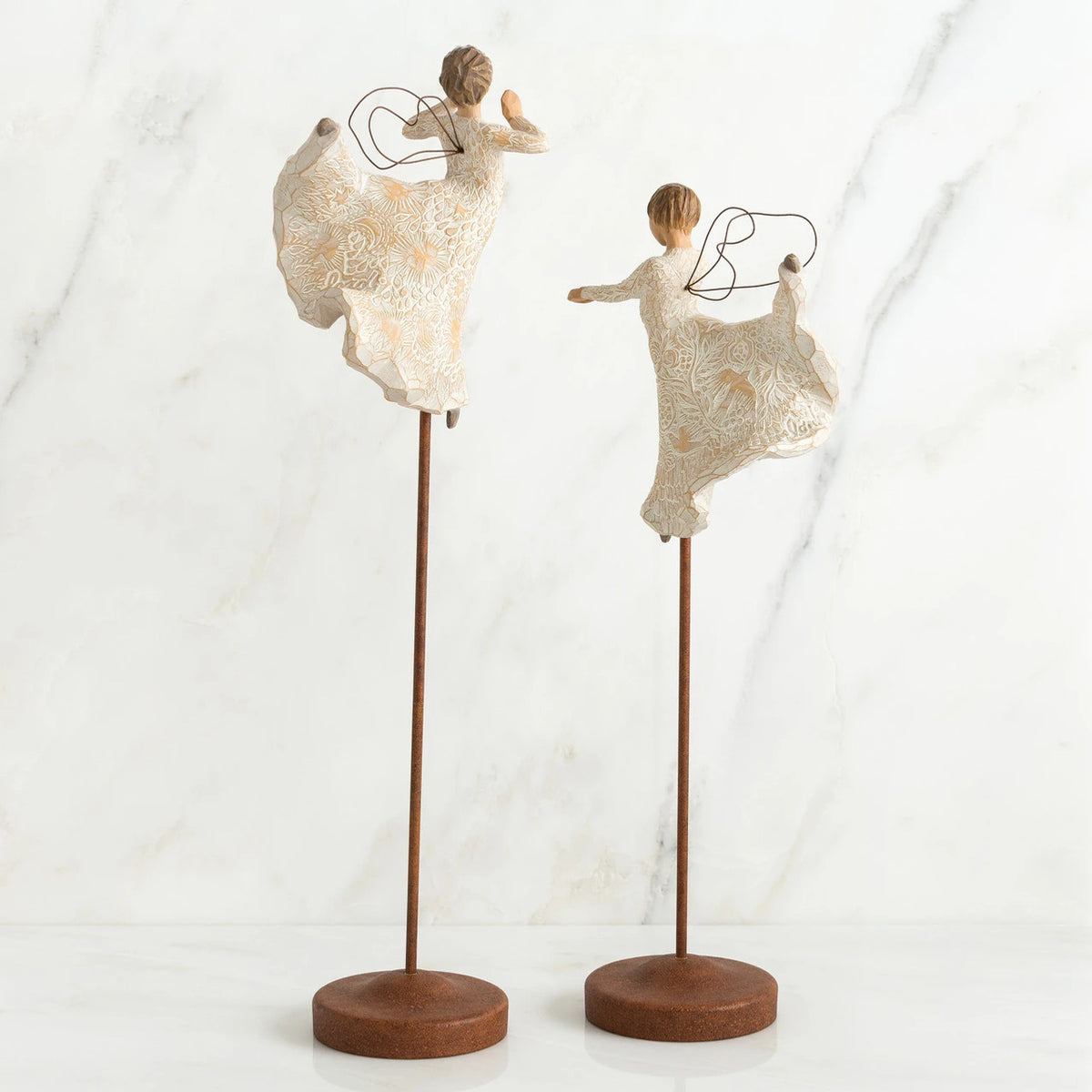 Set of two angel figurines in white dresses danging on wooden stands