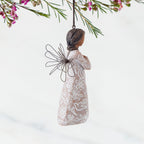 Right Side: Angel Ornament with wire wings, darker skin, dress carved with symbols of remembrance