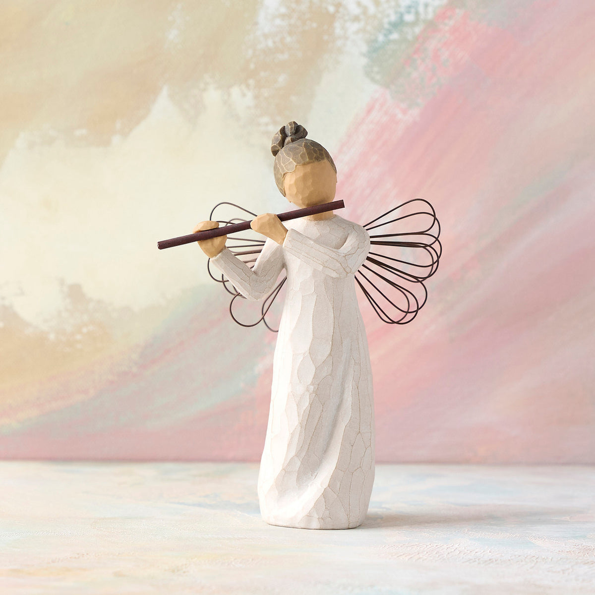 Willow Tree Angel of Harmony, 6"h hand-painted standing resin figure in cream dress with wire wings, playing the flute, in front of pale pink painting