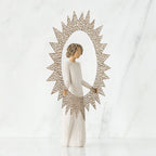 Brunette girl figurine in white dress holding up rose gold sun figurine