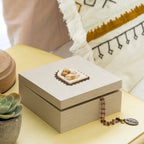Willow Tree Holy Family Memory Box, 4.75”sq x 2.5”h hand-painted cream wood box, closed hinged lid has bas-relief metal-edged carving of the Holy Family affixed to top and ‘A child is born’ sentiment inside