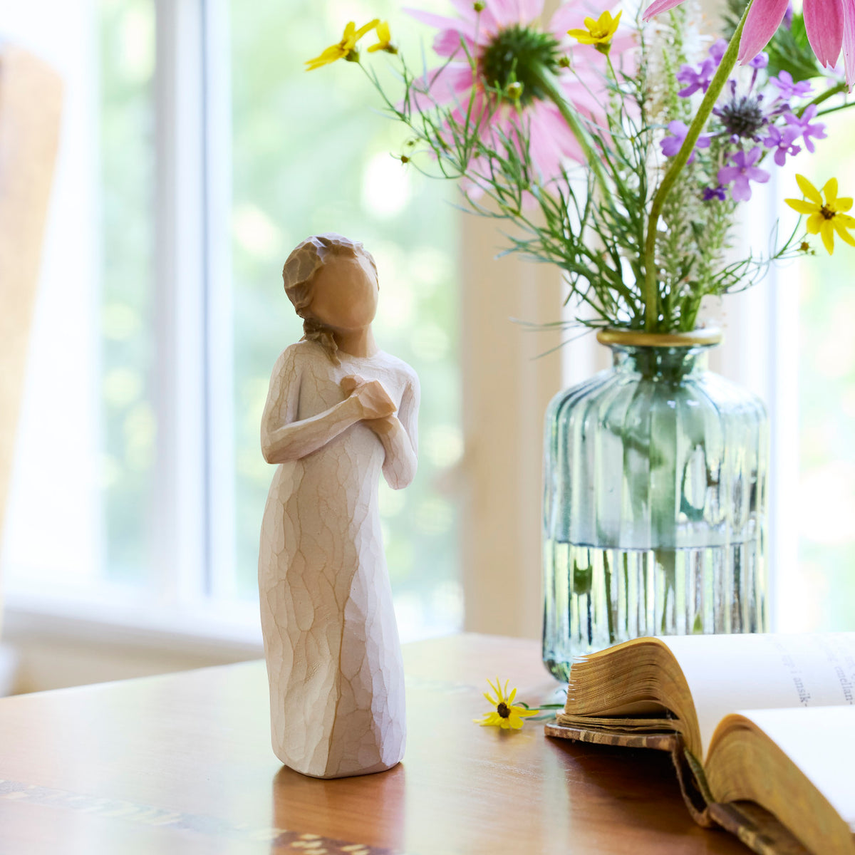 Willow Tree Here for You, 5”h hand-painted standing figure in cream dress, hands to heart in empathetic gesture, on table near window