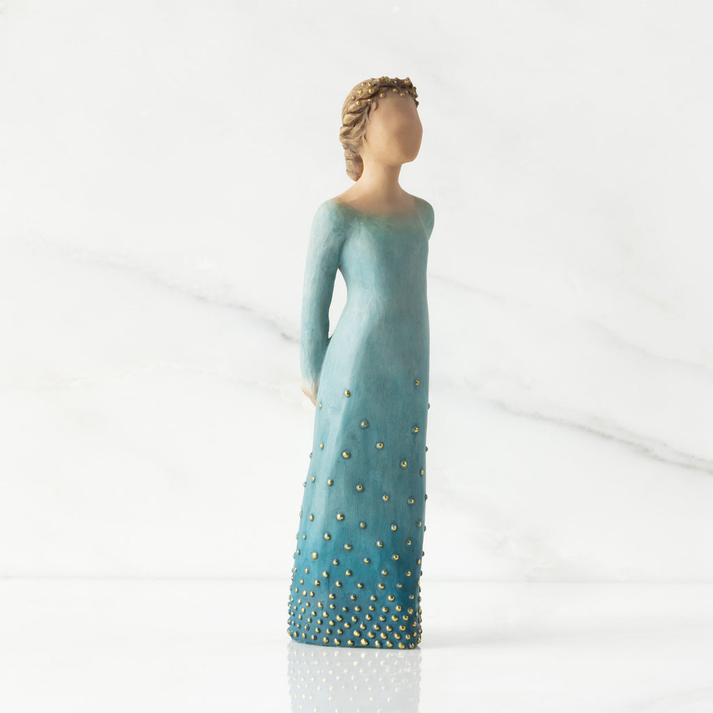 Facing front/right: Lighter-skin figure, arms clasped behind back, hair and deep blue ombré garment dotted with gold leaf