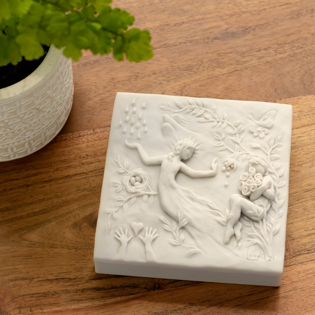 Willow Tree A Healing Wish Keepsake Box, 5"sq x 1.75"H hand-painted off-white resin box, detatched lid carved with organic/figural symbols, sentiment inside lid and velvety finish inside base, on wood table